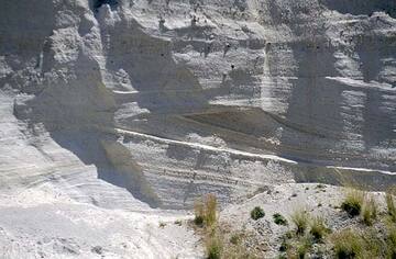 Ash deposits from numerous, turbulent pyroclastic flows during the Minoan eruption of Santorini volcano, Greece.