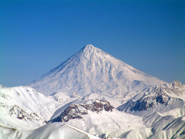 Conical snow-capped Damavand volcano is the highest volcano in the Middle East. It towers dramatically 70 km to the NE above Iran's capital city of Tehran. Activity at the 5670-m-high stratovolcano has been dominated by lava effusion. Young lava flows erupted from the summit vent blanket the western side of the volcano, and the youngest dated lava flows were erupted about 7000 years ago. Photo by Arad Mojtahedi, 2006 (http://en.wikipedia.org/wiki/Image:Damavand_in_winter.jpg)