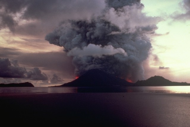 Eruption of Banda Api in 1988 - a large fissure has cut the island in half, producing dense ash emissions and lava flows on both sides that destroyed the village of Batu Angus on the north flank (image: Tom Casadevall / USGS)