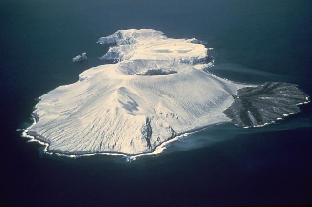 Bárcena volcano here from the SW in March 1955. The tuff cone with the circular summit crater containing a lava dome, and the lava delta to the right formed during the 1952-53 eruption. Photo by Adrian Richards, 1955 (U.S. Navy Hydrographic Office).