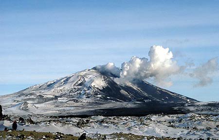 Hekla in eruption in March 2000 with the large black lava flow in the foreground from that eruption.