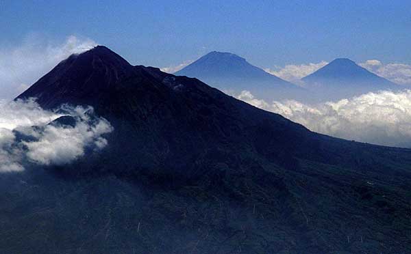 Merapi (left) with Sumbing (center) and Sundoro (right) volcanoes in Central Java seen from the east.