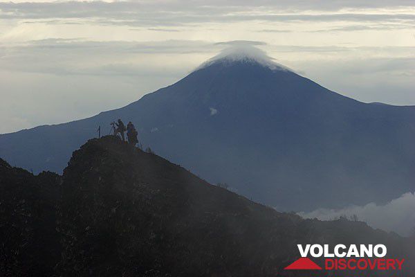 Karisimbi volcano with snow cover seen from the rim of Nyiragongo