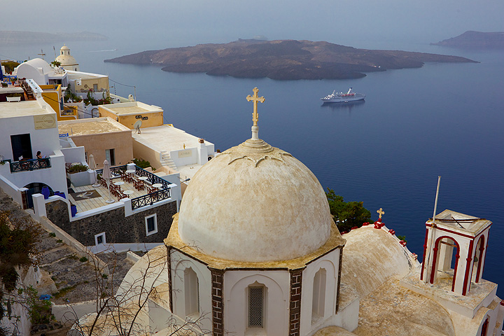 View of the caldera of Santorini from Fira town, with the young volcanic island of Nea Kameni in the background.